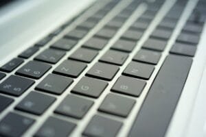 Close-up image of a laptop keyboard showing a section from the letters T to N, designed for an enhanced fan experience. The keys are arranged in a QWERTY layout, with a metallic finish surrounding them, and the perspective is angled from the side.