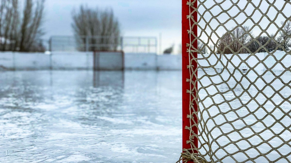 Red hockey goal net on an outdoor ice rink