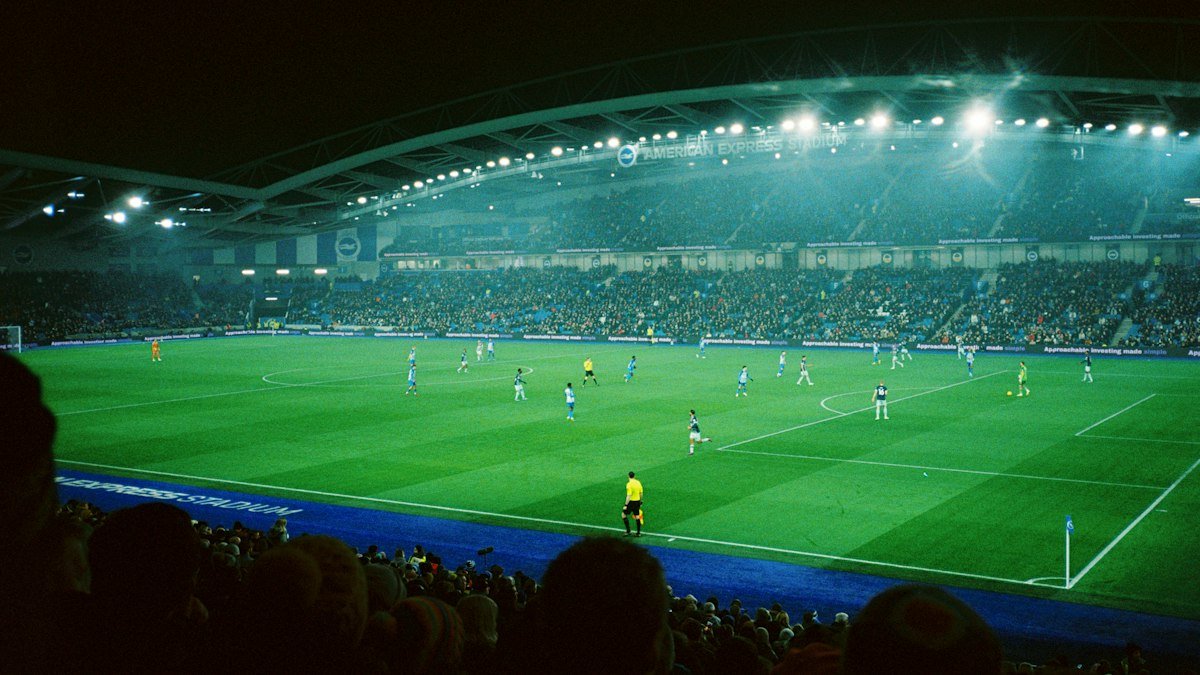 Soccer match under the lights in a packed stadium at night